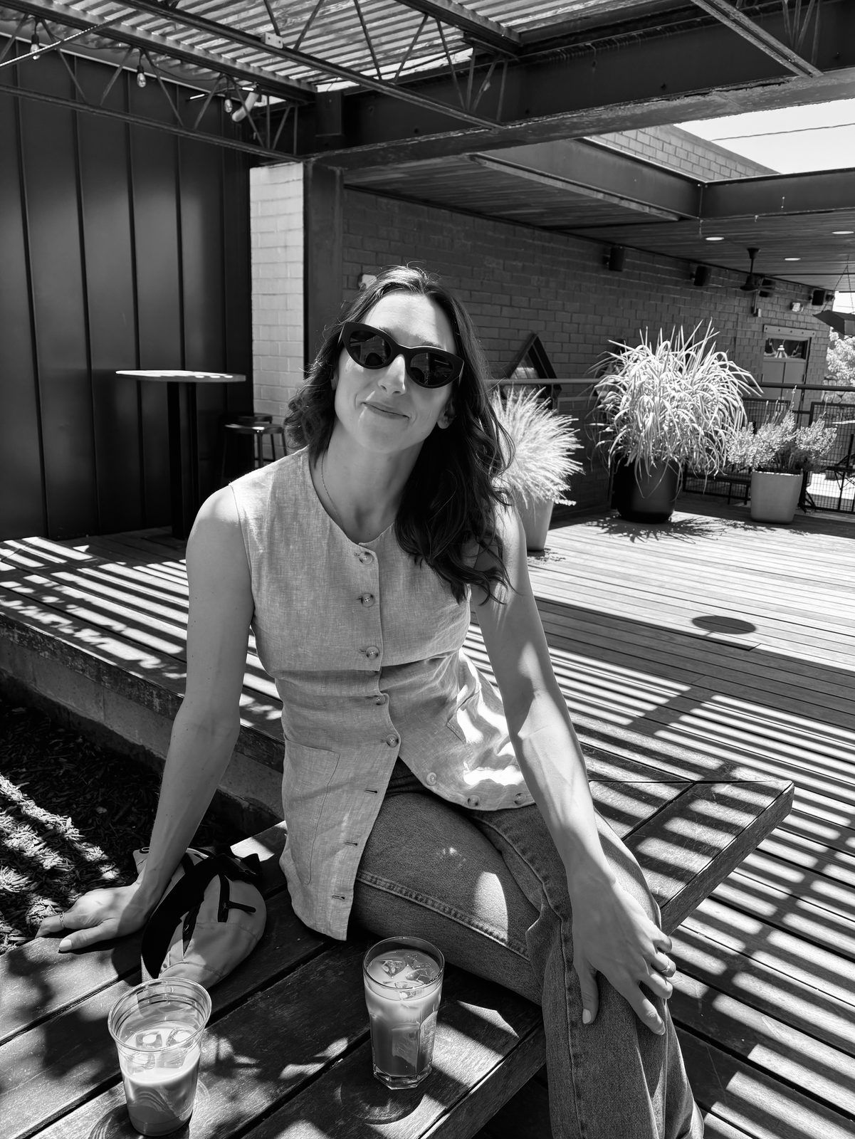 Carla Diaz sitting outdoors on a sunny patio